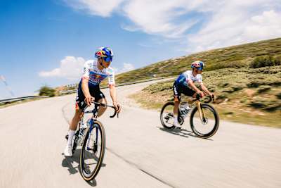 Florian Lipowitz and Remco Evenepoel of Red Bull – BORA – hansgrohe cycle through Sierra Nevada during the 2026 Tour de France jersey photoshoot, showcasing dynamic team energy