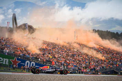 Max Verstappen drives for Red Bull Racing during the 10th stop of the 2023 FIA Formula One World Championship at the Red Bull Ring in Spielberg, Austria, amid spectacular orange smoke