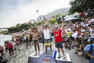 Second placed Sergio Guzman, and event winner Jonathan Paredes of Mexico, and third place David Colturi (R) of the USA celebrate during the Red Bull Cliff Diving World Series, Mostar August 15, 2015