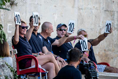 The judges score the last dive from Constantin Popovici (not in photo) of Romania during the Red Bull Cliff Diving World Series in Mostar, Bosnia and Herzegovina on August 24, 2019.