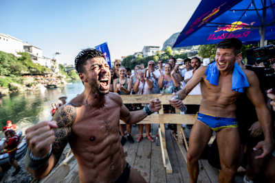 Carlos Gimeno of Spain celebrates victory as Oleksiy Prygorov watches during the 2023 Red Bull Cliff Diving World Series final day in Mostar, Bosnia and Herzegovina