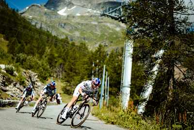 FDJ UNITED-SUEZ riders race down alpine roads of Tignes in their new Red Bull helmets