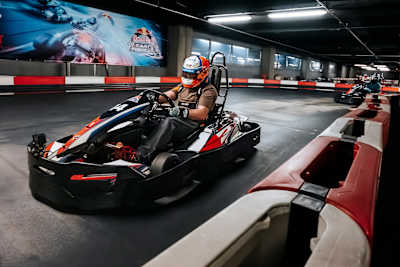 A participant powers through an indoor circuit during Red Bull Kart Fight in Sofia, Bulgaria, on 28 March 2026, with fellow drivers close behind