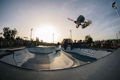 Tom Schaar soars above the bowl during Red Bull Bowl Rippers 2023 in Marseille, France, thrilling the packed crowd with a spectacular skateboard trick.