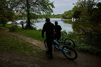 Kriss Kyle and Danny MacAskill wheel their bikes towards the craziest bike obstacle course project at Eastnor Castle, United Kingdom in May 2026.