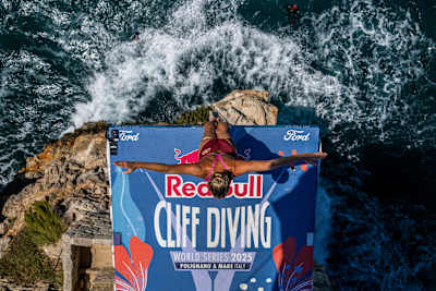 Rhiannan Iffland of Australia launches from the 22-metre platform during the 2025 Red Bull Cliff Diving World Series final in Polignano a Mare, Italy