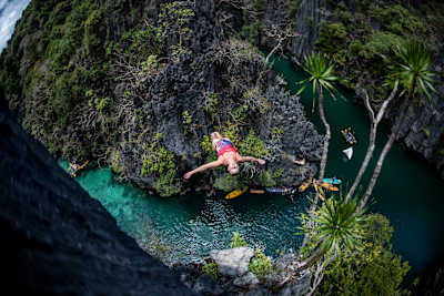 Rhiannan Iffland of Australia dives from a rock pinnacle at the Small Lagoon on Miniloc Island during the first competition day of the Red Bull Cliff Diving World Series in Palawan, Philippines