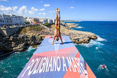 On 26 September 2026, Romania’s Constantin Popovici holds an armstand on the 27-metre platform during the Red Bull Cliff Diving World Series in Polignano a Mare, Italy