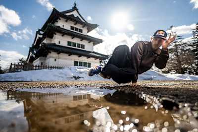 B-Boy Menno strikes a dynamic breakdancing pose before snow-covered Hirosaki Castle during the Red Bull BC One All Star Tour Japan in 2025