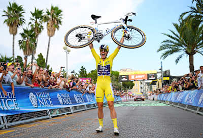 Demi Vollering of FDJ United Suez lifts her bike after winning Stage 9 and the 2026 Tour de France Femmes overall title in Nice, France.