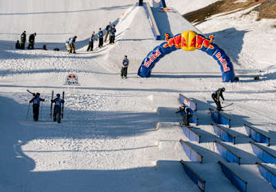 On April 30th, 2026, Jesper Tjäder and Emil Granbom take on the Best Trick challenge at Red Bull Unrailistic in Åre, Sweden, showcasing daring park skiing skills on the innovative rail setup
