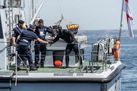 Ross Edgley prepares to swim against a British Royal Navy shipping vessel during his Great British Swim attempt.