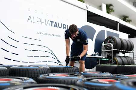 A Scuderia AlphaTauri team member works on tyres in the Paddock during previews ahead of the F1 Grand Prix of Mexico at Autodromo Hermanos Rodriguez on October 26, 2023 in Mexico City, Mexico.