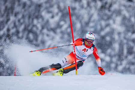 Switzerland's Daniel Yule knocks a slalom pole away with his hand.