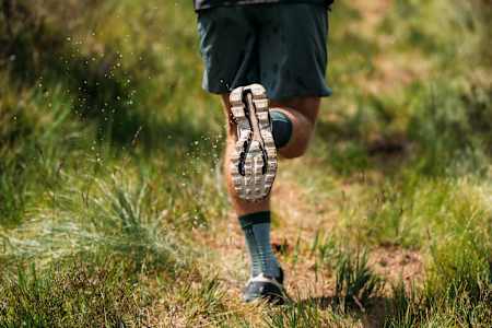 Ultrarunner Florian Neuschwander runs along a trail in his ON running shoes.
