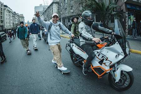 Marcelo Jimenez hitches a ride during Go Skateboarding Day in Santiago, Chile on June 21, 2022.