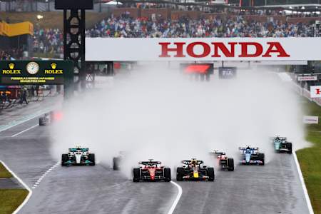Max Verstappen and Charles Leclerc battle for track position into turn one at the start during the F1 Grand Prix of Japan at Suzuka International Racing Course on October 9, 2022.