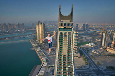 Jaan Roose (EST) slacklining between the Katara Towers building in Doha, Qatar in 2023. 