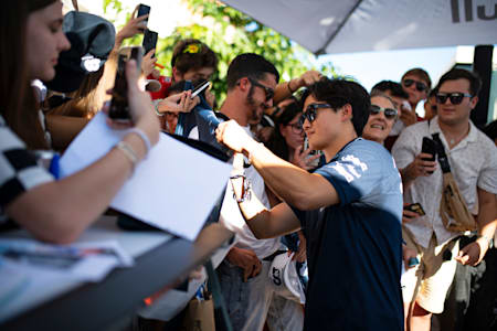  Yuki Tsunoda of Japan and Scuderia AlphaTauri signs autographs during the Scuderia AlphaTauri Premiere of "Whatever it Takes – the Race before the Races" on September 06, 2023 in Venice, Italy. 