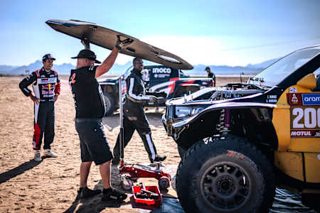 In the 2024 Rally Dakar shakedown, Toyota Gazoo Racing SA mechanics work on their rally car in Al Ula, Saudi Arabia.