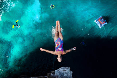 Rhiannan Iffland soars into the crystal clear waters at the European home of cliff diving in Polignano a Mare, 2022