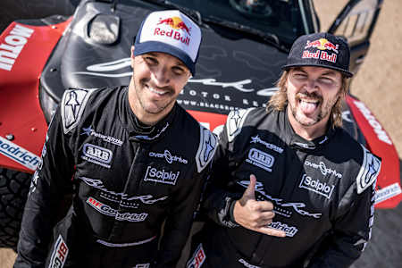 Toby Price and Sam Sunderland, Red Bull racers, grinning before Dakar Rally 2025 training.