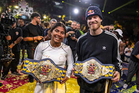 B-girl Indiaand B-boy Menno of the Netherlands celebrate with the winners belts during the Red Bull BC One World Final at Farmasi Arena, Rio de Janeiro, Brazil on December 7, 2024. 