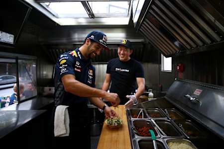 Daniel Ricciardo helps out at a food truck during previews to the United States Formula One Grand Prix in 2015. 