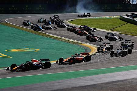 Max Verstappen leads Lando Norris through turn one at the start during the Sprint ahead of the F1 Grand Prix of Brazil at Autodromo Jose Carlos Pace on November 04, 2023 in Sao Paulo, Brazil.