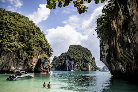 Orlando Duque and Jonathan Paredes watch as Michal Navratil dives from the 27 metre platform on Hong Island at the Red Bull Cliff Diving World Series, Krabi, Thailand on October 25th 2013.