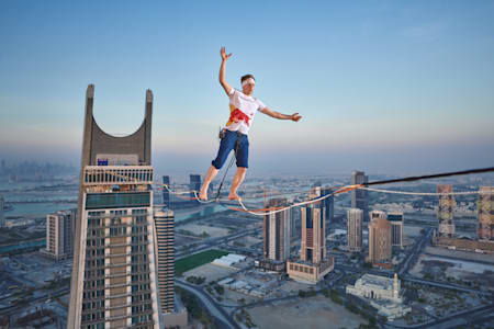 Jaan Roose (EST) perfoming between Crescent (Katara) building Towers in Doha, Qatar on June 20, 2023.