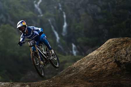 Ronan Dunne riding in front of the Hardline waterfall at Red Bull Hardline 2024 Dinas Mawddwy, United Kingdom on May 31, 2024