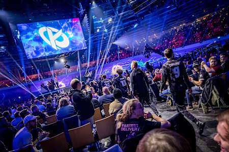 Red Bull League of Its Own event at Venue Venue in Berlin, showcasing an energetic esports competition atmosphere with players on stage amidst vibrant lighting and graphics displays