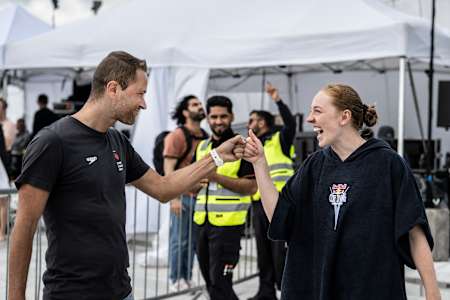 Stephane Lapointe (L) and Molly Carlson react during the first competition day of the Red Bull Cliff Diving World Series at the Oslo Opera House, Norway on August 8, 2024.