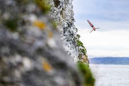 Molly Carlson of Canada dives from the 19.5-metre cliff during the fourth stop of the 2024 Red Bull Cliff Diving World Series at Kinbane Castle, Causeway Coast, Northern Ireland, on July 19, 2024. 