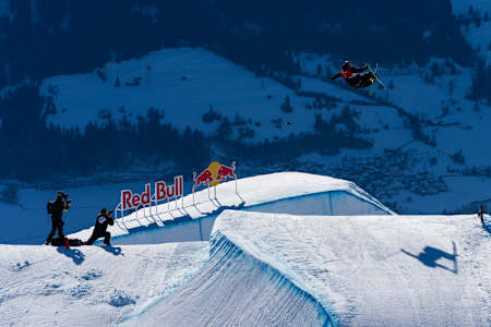 In 2025, Mac Forehand soars over Red Bull branding at Laax Open freestyle skiing event in Switzerland.