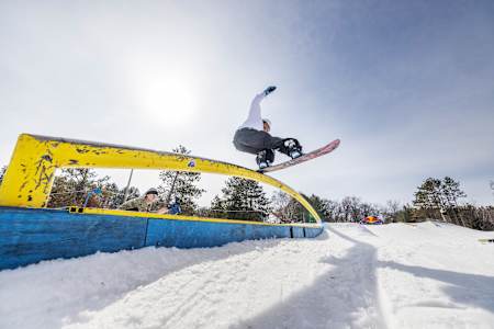 Zeb Powell hits a rail at the Red Bull Slide In Tour at Trollhaugen Ski Area in Dresser, Wisconsin, USA, on March 2, 2024. 