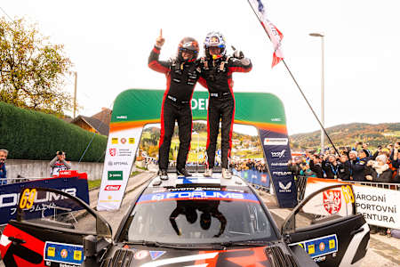 Kalle Rovanperä and Jonne Halttunen of Toyota Gazoo Racing Wrt celebrate on the podium in first place after winning the World Rally Championship in Passau, Germany, on October 19, 2025.