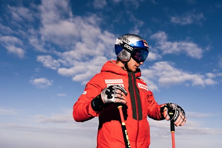 Marco Odermatt, wearing his Red Bull helmet and racing gear, prepares for action during the 2025 training camp in Zermatt, Switzerland, embodying pure alpine adventure and Red Bull spirit