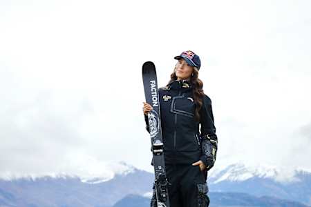 Eileen Gu poses with her skis in Wanaka, New Zealand, against a stunning mountainous backdrop in September 2025.