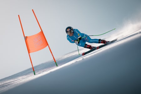 Sofia Goggia powers through a gate during the filming of I'm Coming Home in Moena, Italy, on April 7, 2025, displaying speed and precision on the icy slope.