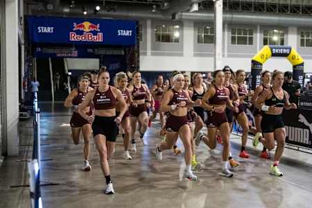 Lucy Procter leads a dynamic start at the Hyrox World Championship in Chicago, USA on June 14, 2025, under the iconic Red Bull banner. Athletes showcase peak endurance and competitive spirit.