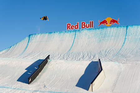 Mark McMorris executes a jump amidst clear skies during the Laax Open in Switzerland on January 15, 2025.