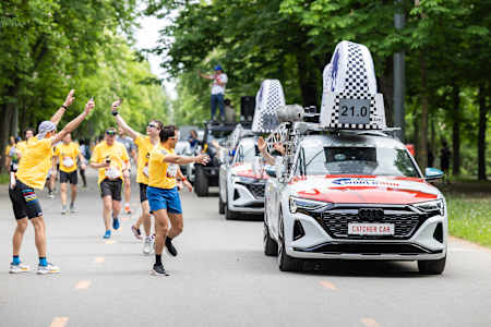 Excitement at the Wings for Life World Run in Vienna, Austria, May 2024, as runners engage with the iconic Catcher Car