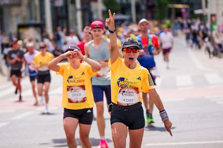 Participants radiate energy and excitement during the Wings for Life World Run 2024, held in Vienna, Austria, showcasing determination for a good cause.