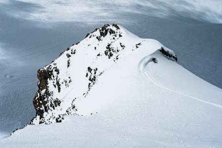 Manon Loschi slashing pow during the Red Bull Alpine Camp in Zermatt on May 17, 2024.