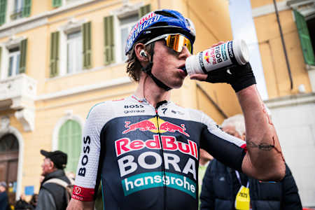 Laurence Pithie of Red Bull BORA-hansgrohe hydrates during Milano-Sanremo in San Remo, Italy, March 2025, showcasing endurance and performance on the legendary cycling stage.