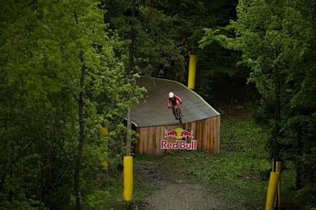 Loïc Bruni navigates a feature on the downhill course during the UCI Mountain Bike World Cup 2025 in Bielsko-Biala, Poland.