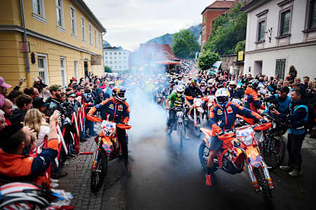 A dynamic scene captures Manuel Lettenbichler and Josep Garcia at the Red Bull Erzbergrodeo 2024 in Eisenerz, Austria, thrilling the crowd amid roaring motorcycles and adrenaline-fueled energy
