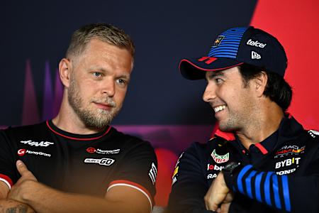 Kevin Magnussen and Sergio Perez in conversation before the 2024 F1 Australian Grand Prix.